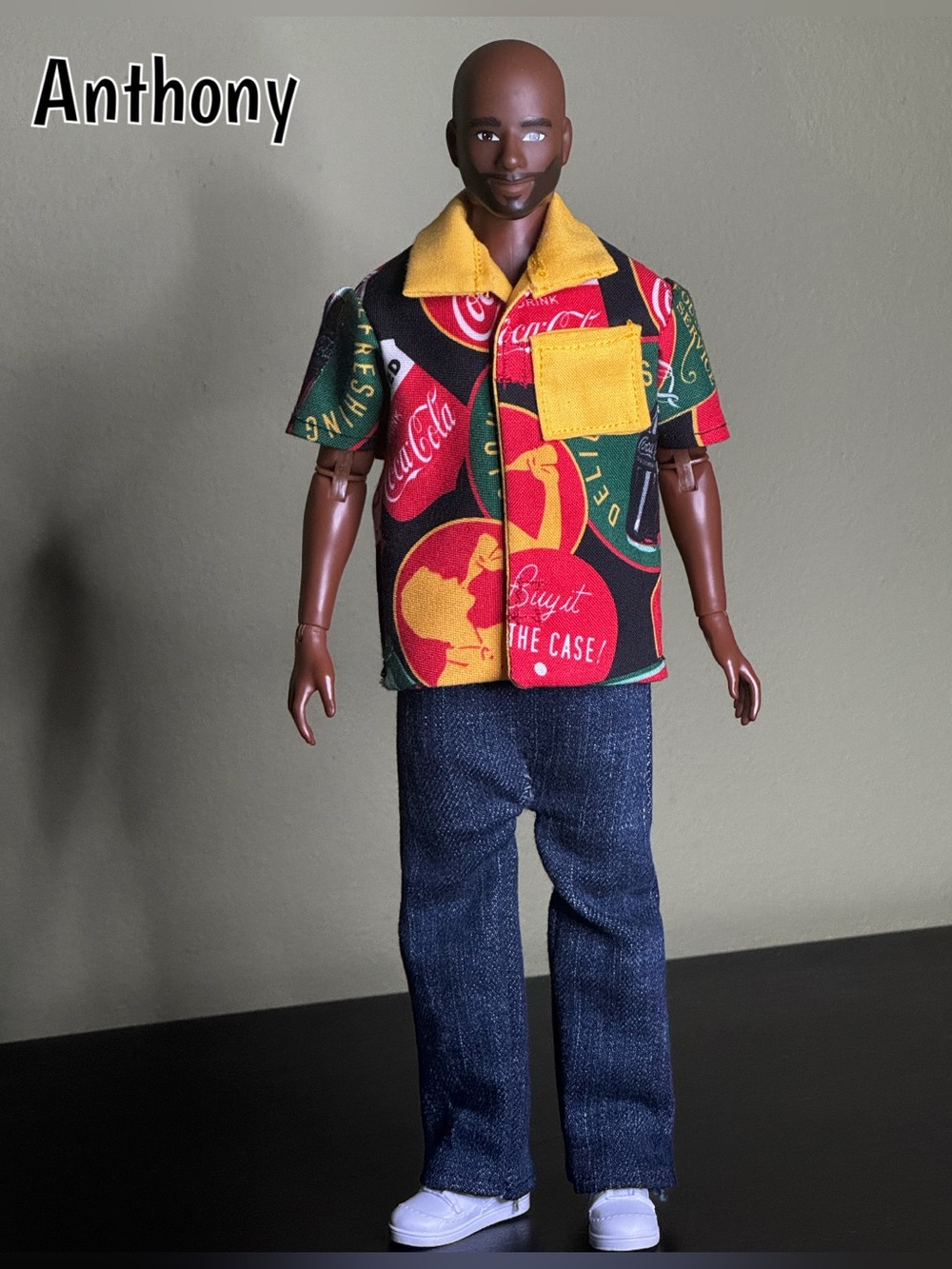 Handcrafted Coca-Cola themed doll shirt with yellow collar and pocket